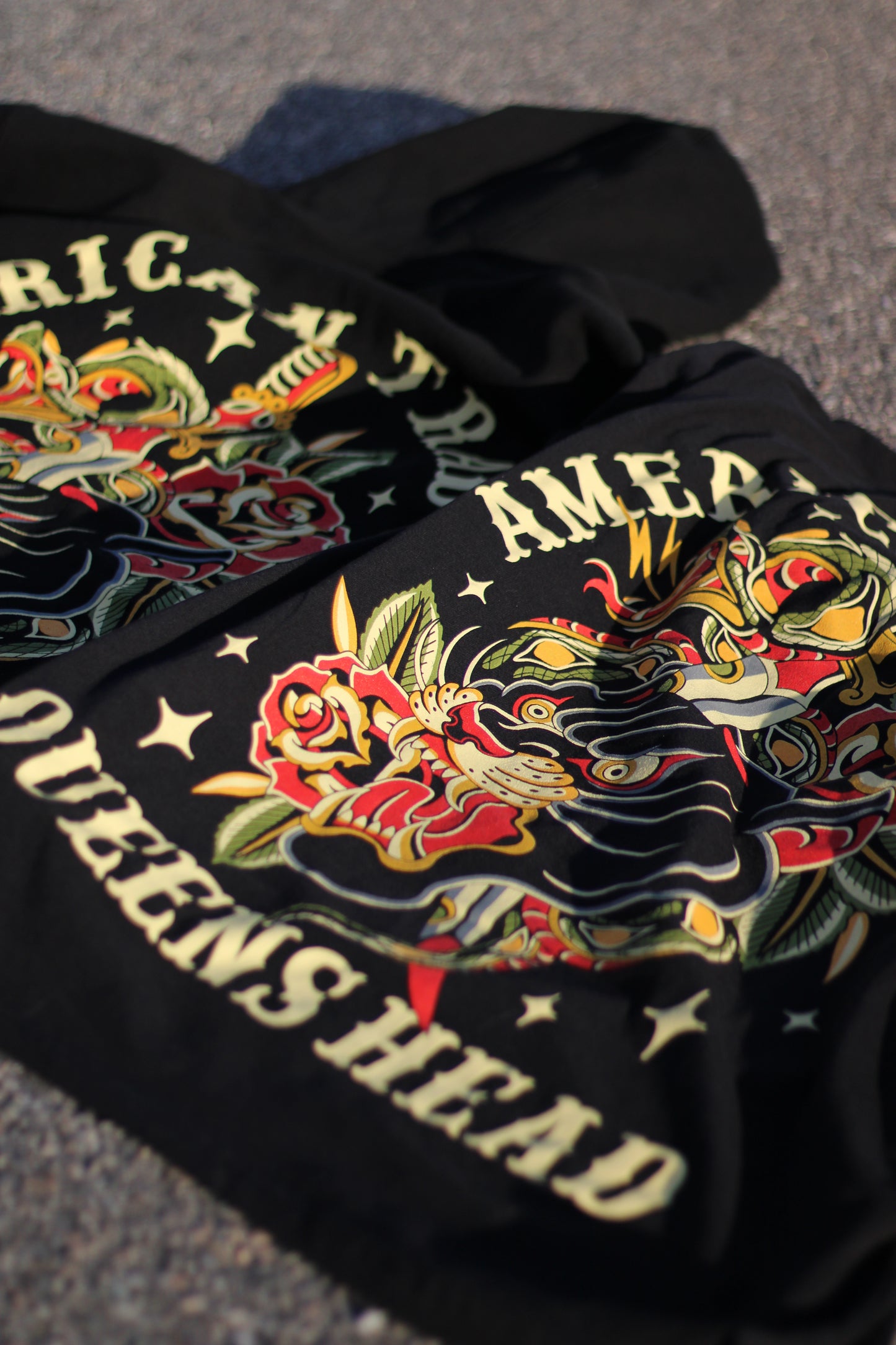 Back of Queens Heads First Bite tattoo graphic tee, American traditional design in black.